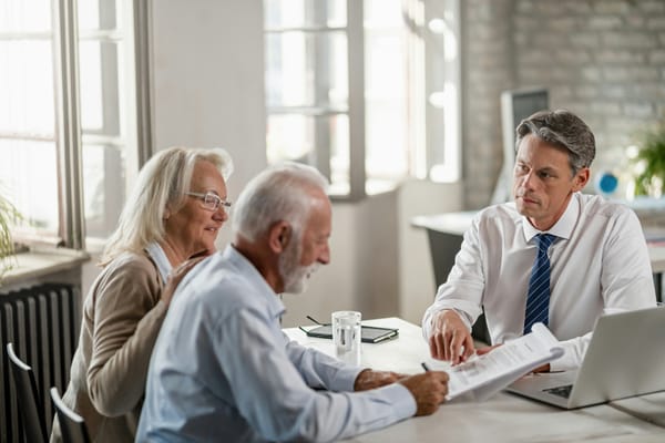 Couple meeting with a care advisor to plan for long-term care