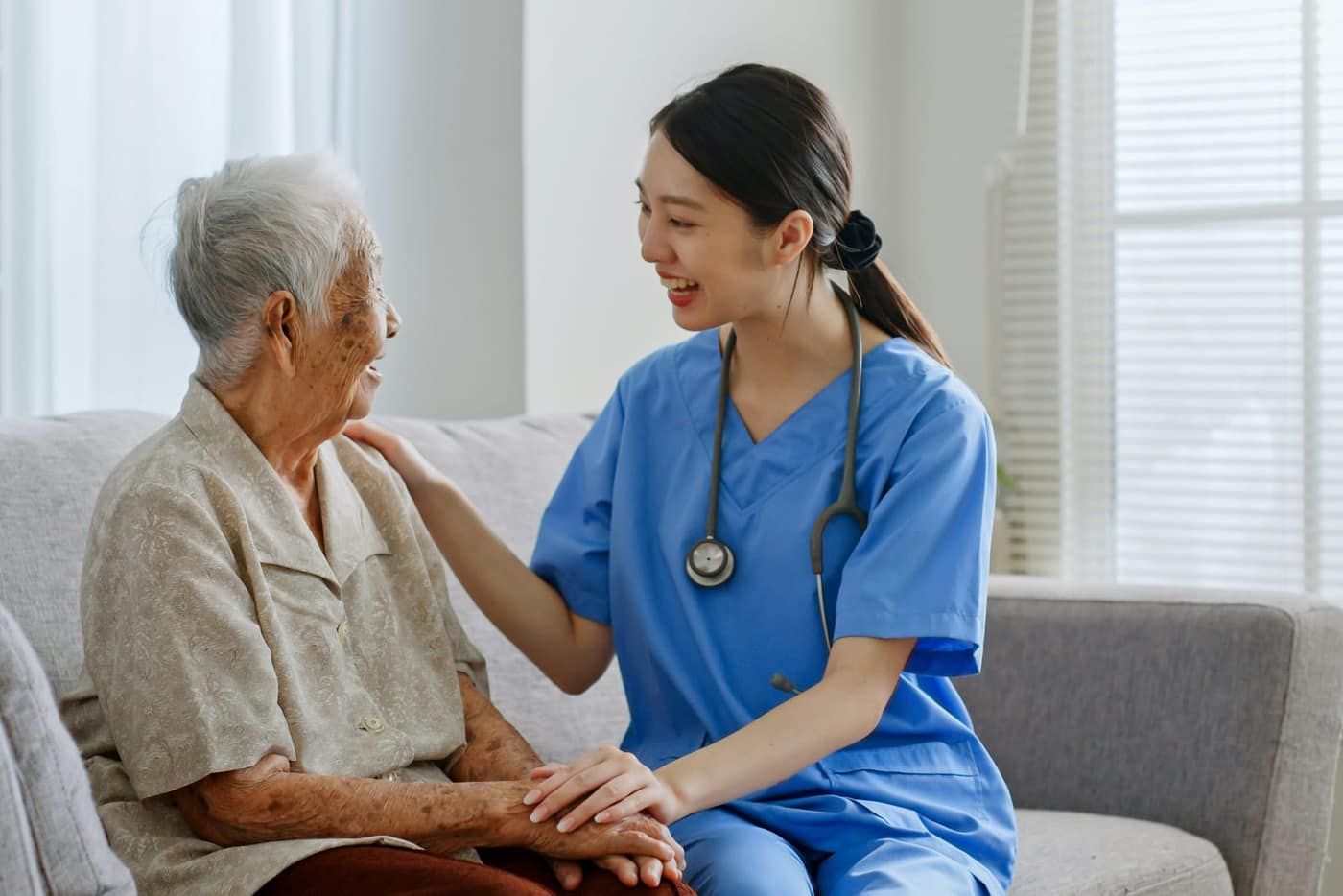 Adult son reviewing care level options with his elderly father at home