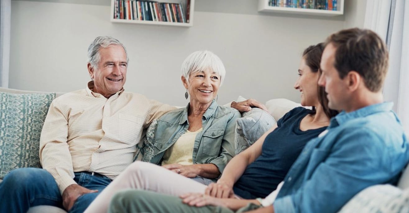 Adult daughter holding her aging mother's hand during a calm conversation about future care