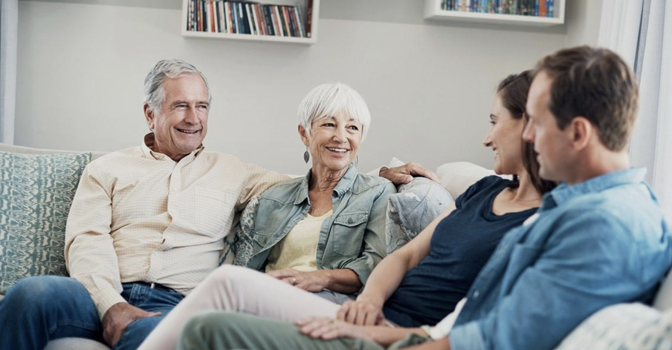 Adult daughter holding her aging mother's hand during a calm conversation about future care