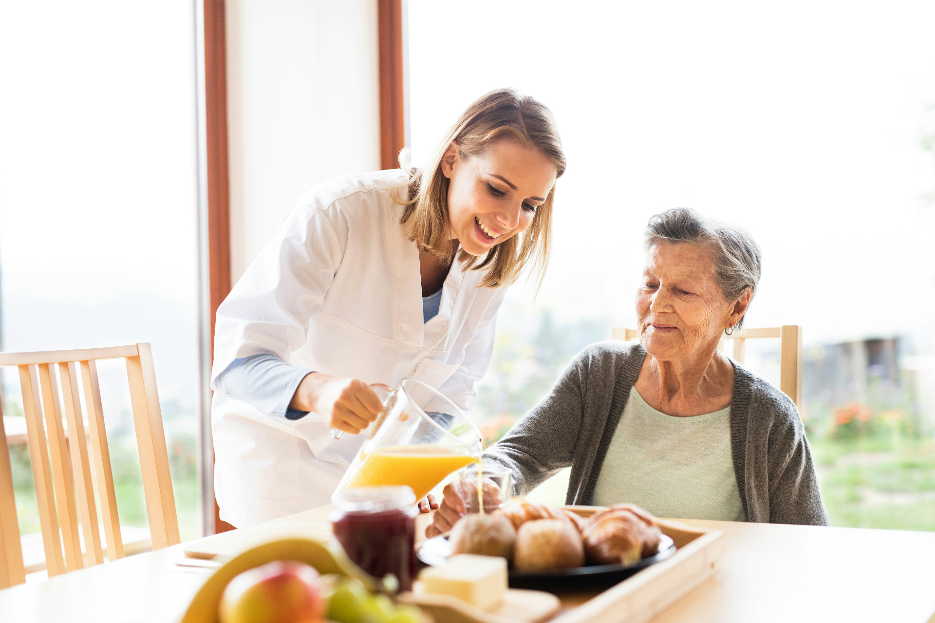 Adult daughter touring a care facility and observing staff interaction with residents